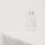 Simple and clean image of a glass jar on a white tablecloth, showcasing minimalism.